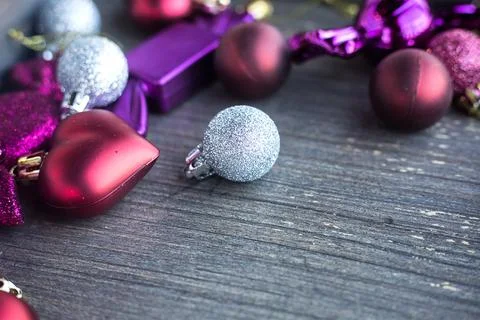 Close up of tiny silver sparkling Christmas ball. New year toys, hearts and Stock Photos