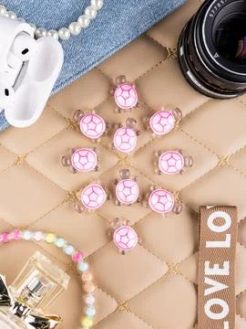Close-up of tiny turtle figurines on a beautiful table with womens accessorie Stock Photos