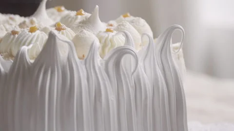 Close up of tip of pastry bag making decorative details with meringue Stock Footage 240750452