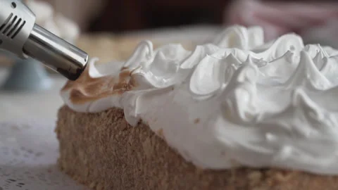 Close up on tip of pastry torch roasting meringue pie topping, selective focus Stock Footage 240934381
