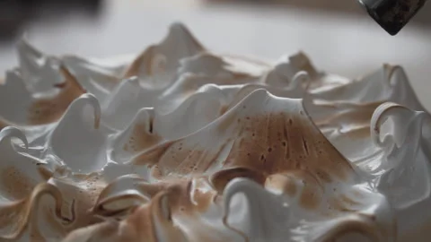 Close up on tip of pastry torch roasting meringue pie topping, natural light, Stock Footage 240936285