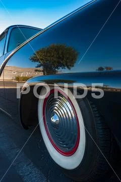 Close up on tire and hubcap of old vintage car Stock Photos