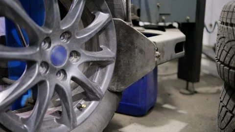 Close-up of a tire changing machine pressing the bead to separate it from the Stock Footage 339273838