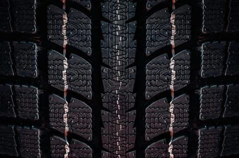Close up on a tire on a dark background Stock Photos