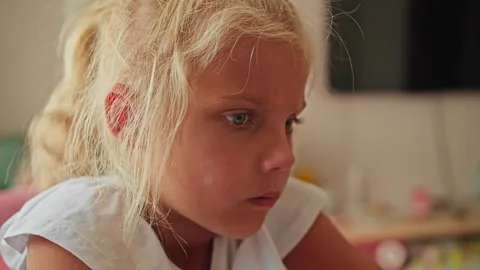Close-up of a tired child studying at home and trying to stay focused Stock Footage 328536839