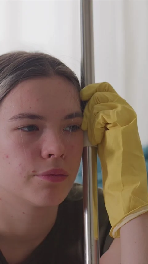 Close up of Tired Cleaner Resting on Mop Handle in Domestic Setting showing Stock Footage 346790453