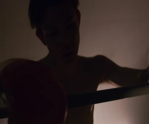 Close up of tired man in boxing ring leaning on ropes with spotlights, Japan Stock Footage 147053597