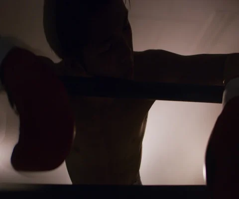 Close up of tired man in boxing ring leaning on ropes with spotlights, Japan Video stock 147055208