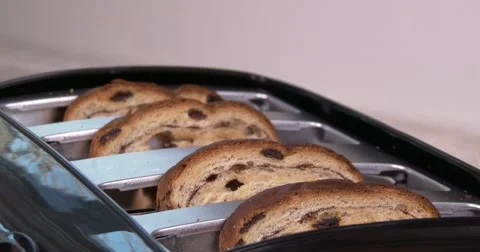 Close up of toast in a toaster, going down and popping up. Multiple takes in 4K Stock Footage 57625062