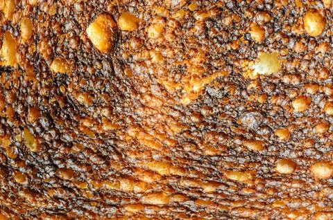 Close-up of toasted bread crust with a bubbly, textured surface Stock Photos