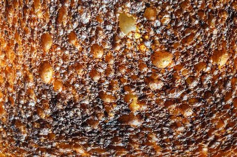 Close-up of toasted bread with a dark, textured surface Stock Photos