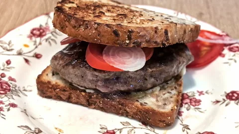 Close-up of toasted sandwich burger with beef meat patty and tomatoes Stock Footage 287450712