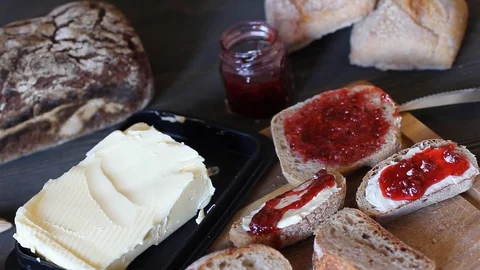 Close-up of toasts with butter and cake. On a wooden table of dark wood lie Stock Footage 79832648