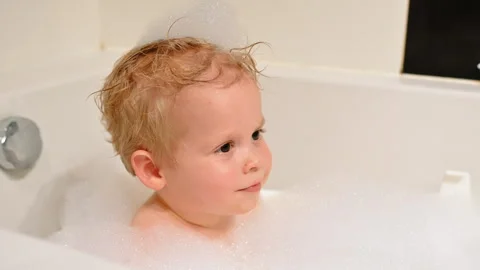 Close-Up of Toddler in Bubble Bath with Foam Hat Stock Footage 307309198