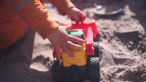 Close up - Toddler playing in sand box with excavator 스톡 동영상 135757052