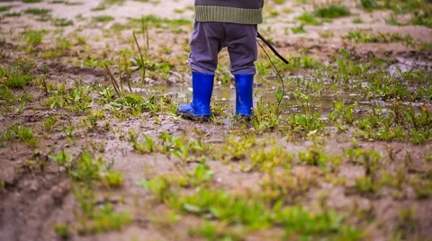 Close up of toddler in rubber boots. Stock Footage 58696473