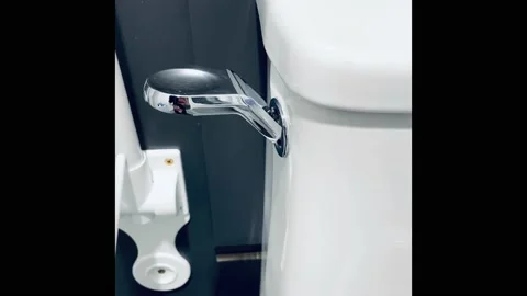 Close-up of toilet flush handle Stock Footage 153780826