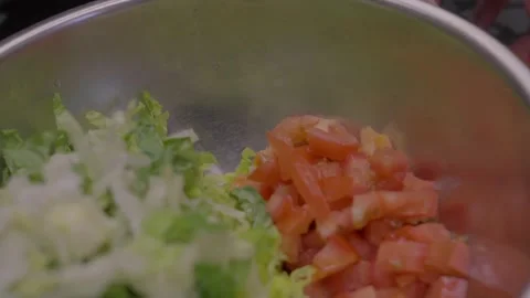 Close up tomato added to bowl of salad Stock Footage 276447341