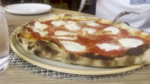 Close-Up of Tomato and Mozzarella Pizza Being Cut with Knife and Fork Stock Footage 319037501