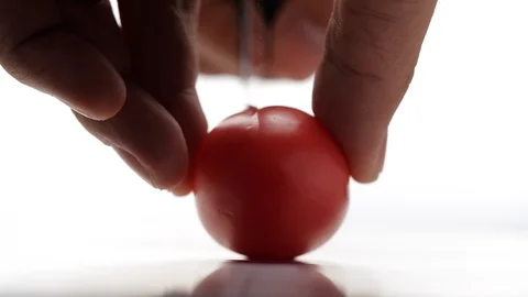 Close-up of Tomato cutting in slow motion on white background Stock Footage 126559392