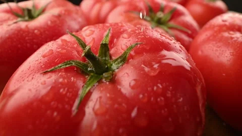 Close-up of a tomato with a drop of water on it. Healthy food advertising. 스톡 동영상 271196714