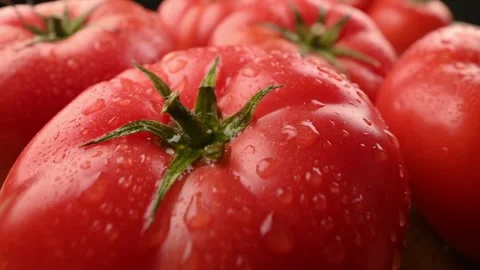 Close-up of a tomato with a drop of water on it. Healthy food advertising. Stock Footage 271196753