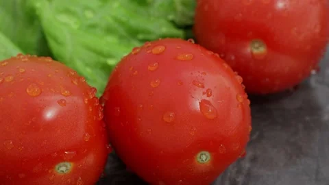 Close-up on a tomato pouring water Stock Footage 227704604