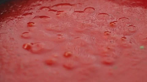 Close up of tomato sauce simmering with bubbles across the surface in pan Stock Footage 341273615
