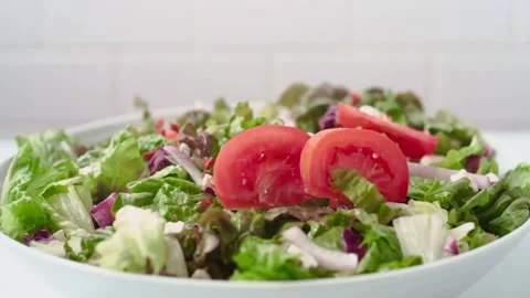 Close-up of Tomato Slices Falling into Fresh Salad Stock Footage 339565804