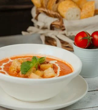 Close up of tomato soup with bread stuffing and cream 2 Stock Photos