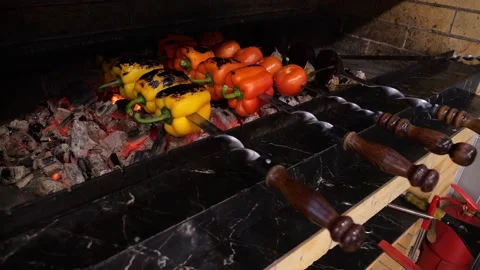 Close-up of tomatoes, peppers and eggplants cooked over charcoal on a grill. Stock Footage 320877635
