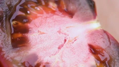 Close-up tomatoes. Sliced black tomato. Macro video. Stock Footage 148526337