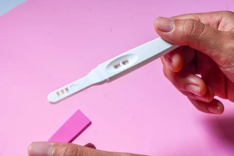 Close up of a tool for checking pregnancy that is being opened and marked w.. Stock Photos
