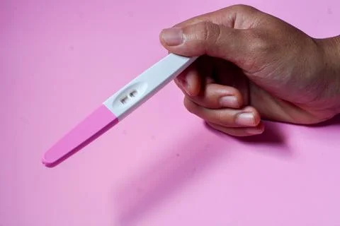 Close up of a tool for checking pregnancy that is being opened and marked w.. Stock Photos