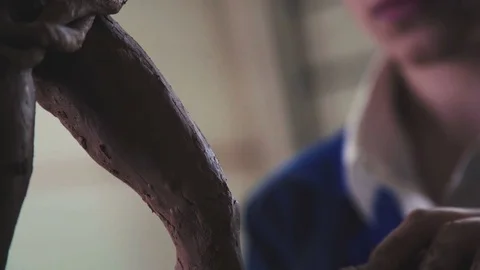 Close-up: tool for clay modeling - a stack-loop - removes excess clay Video stock 74614186