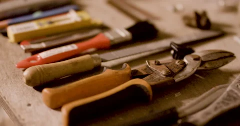 Close up of tools stacked next to eachother on top of table inside garage Stock Footage 163242167