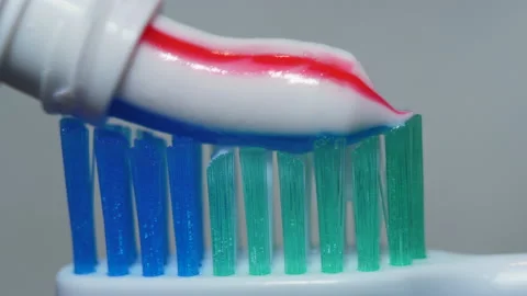 Close-up  Toothbrush With Bright Striped Toothpaste. Macro Shot Red and Blue  Stock Footage 153760833