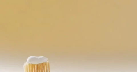 Close up of toothbrush with paste on beige background with copy space Stock Footage 233124007