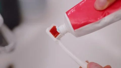 Close Up Toothpaste Being Applied To Toothbrush For Dental Care Stock Footage 321413230