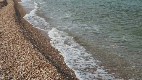 Close up top angle of clean sea waves breaking on sandy beach Stock Footage 157265288