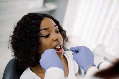 Close- up top angle view of face of attractive African woman patient being Stock Photos