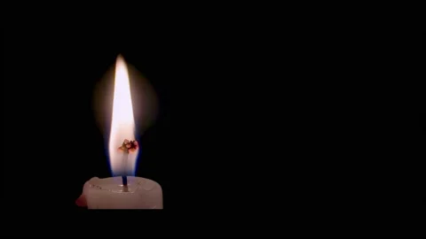 Close-up of the top of a candle with a burning wick, 4k Stock Footage 237065660