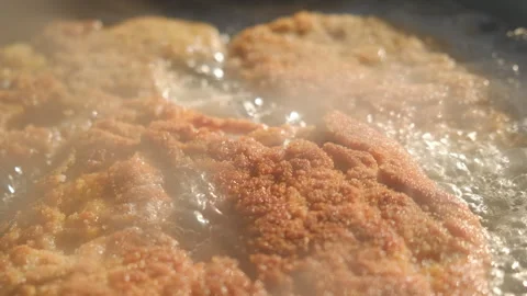 Close up top of crispy chicken fillet cooking in cast iron pan over bonfire Stock Footage 301074739