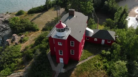 Close up top down aerial of red light house in Marquette Michigan Stock Footage 203567749