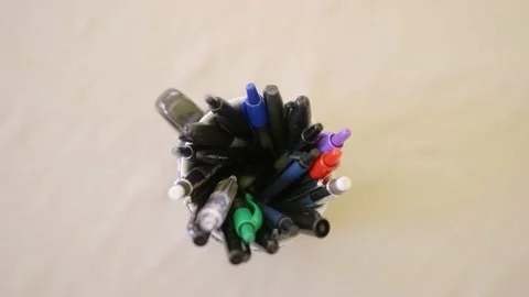 Close up top down hand grabbing pencil out of coffee mug Stock Footage 142845469