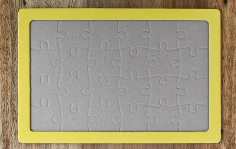 Close up of top down shot of jigsaw puzzle on wood background Stock Illustration