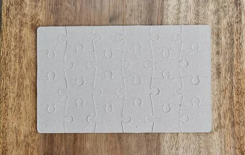 Close up of top down shot of jigsaw puzzle on wood background Stock Illustration