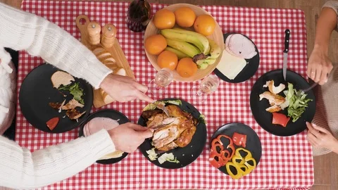Close up top down view of couple eating dinner together and drinking champagne Stock Footage 115570622