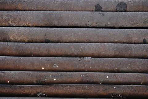 Close-up top-down view of horizontal weathered rusty metal bars 写真素材