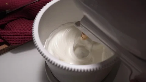 Close up top down view of mixer mixing white cream for cake. Mixer is stopped by Stock Footage 125959994